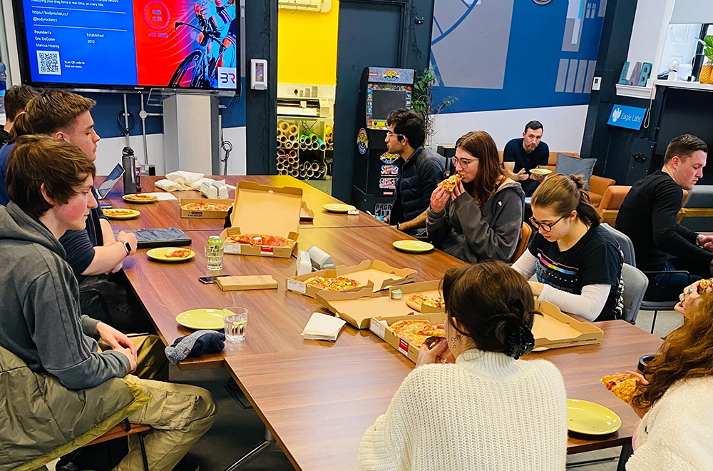 Students tuck into pizza at Make (Good) Trouble and Barclays Understanding Finances event