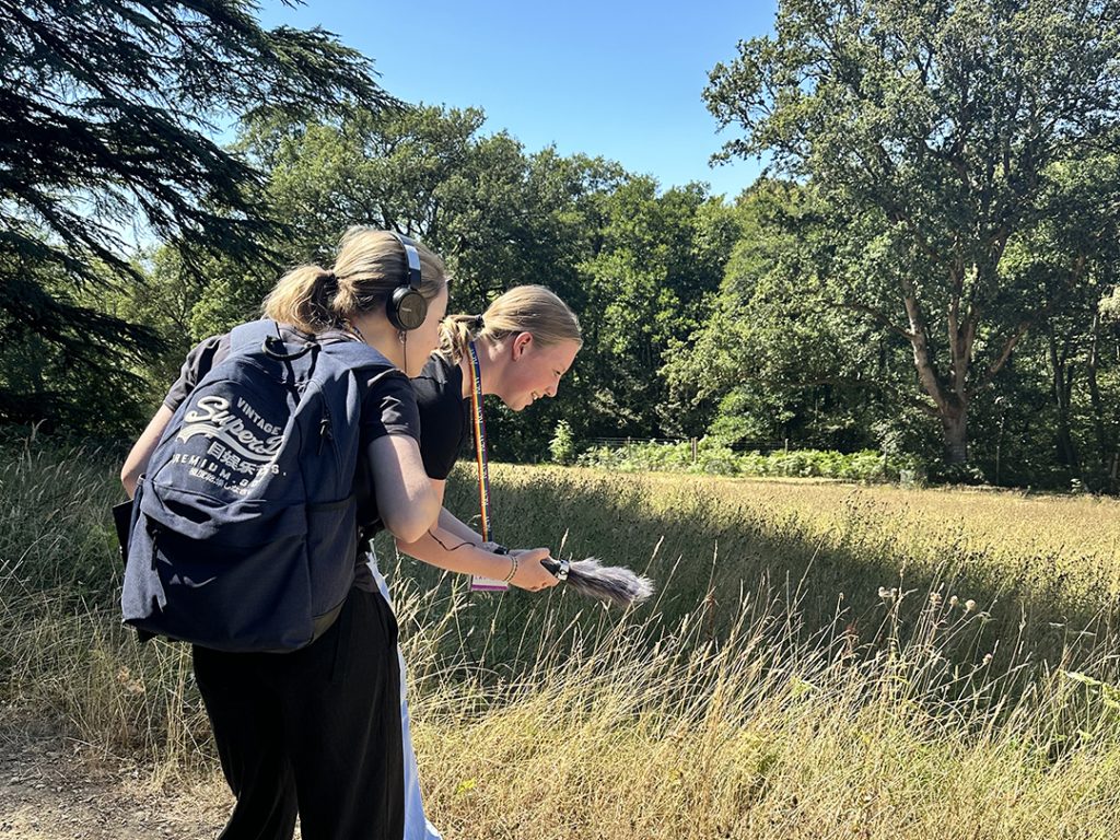 Wakehurst work experience students recording sound effects - a buzzing bee - in the botanic garden